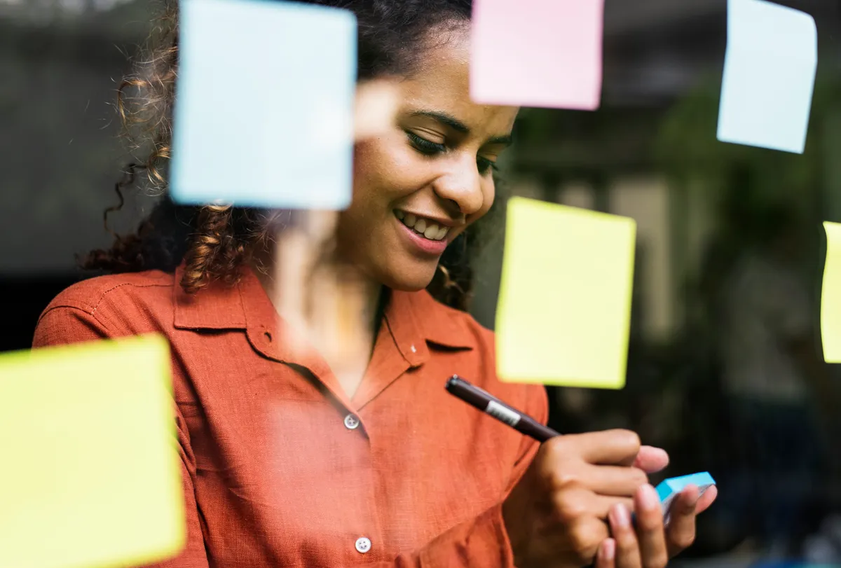 Entrepreneur brainstorming business name ideas using creative naming frameworks