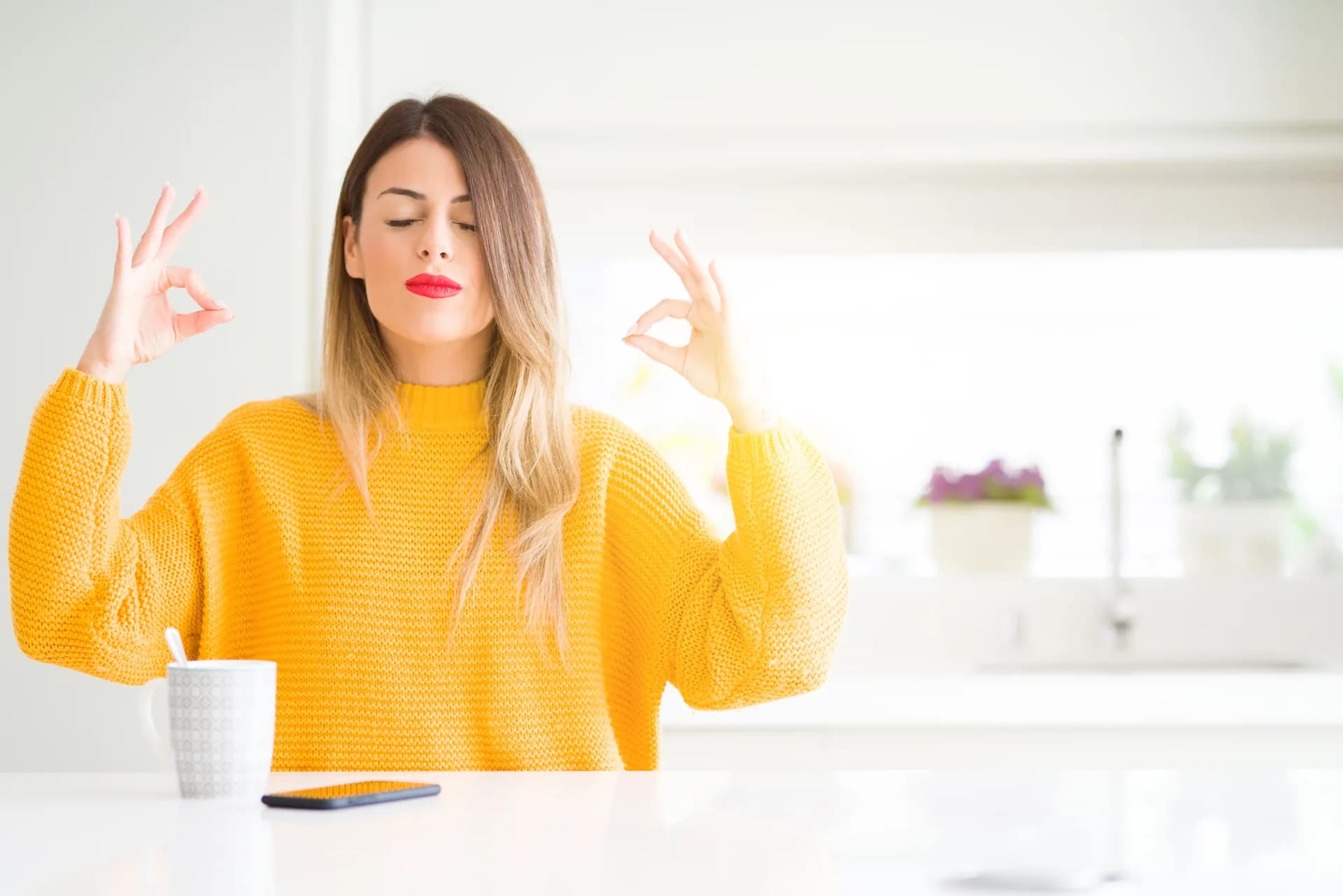 A young woman peacefully holding a coffee mug at home