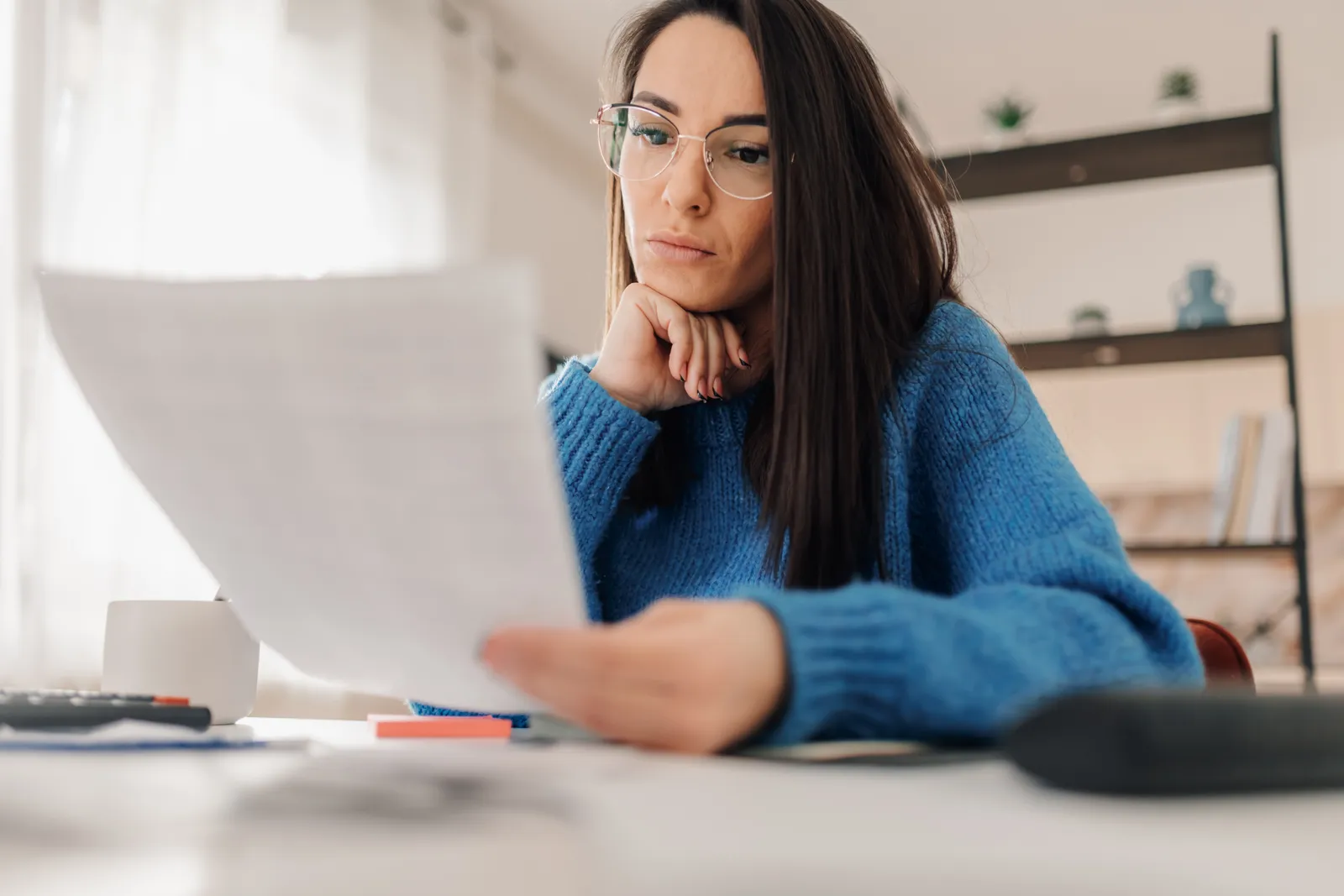 Accountant reviewing a financial statement at her desk