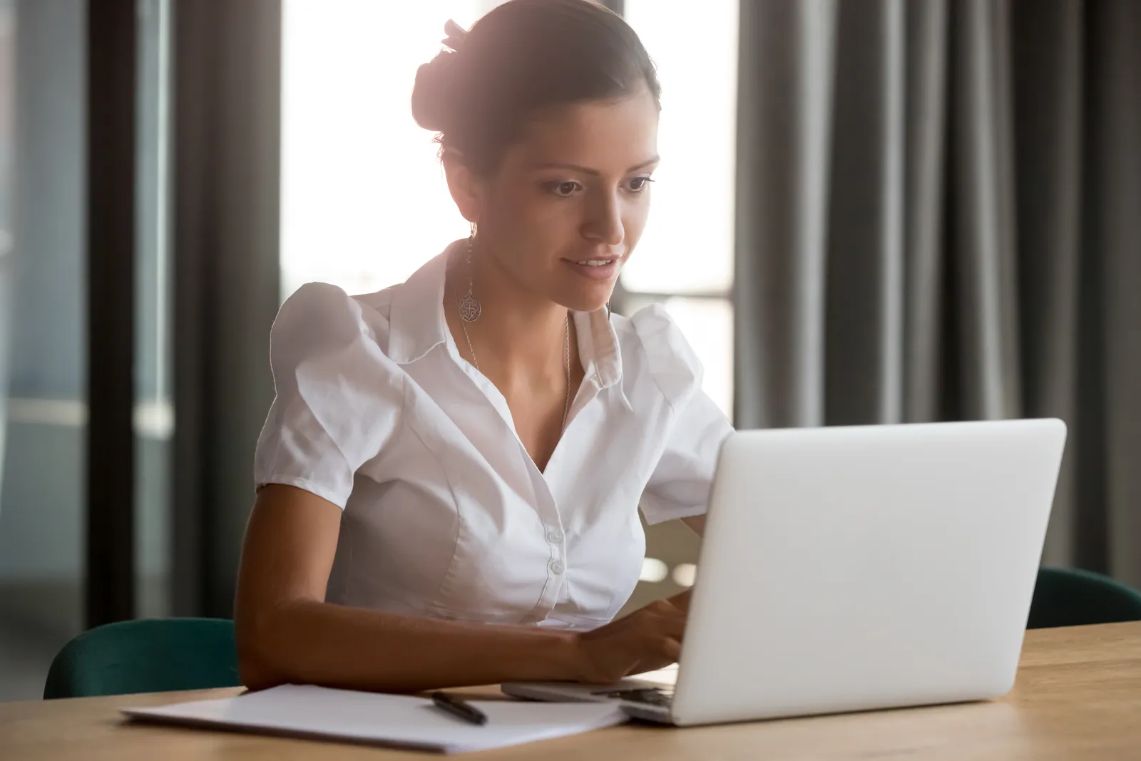 Accountant working on her firm's website at a laptop
