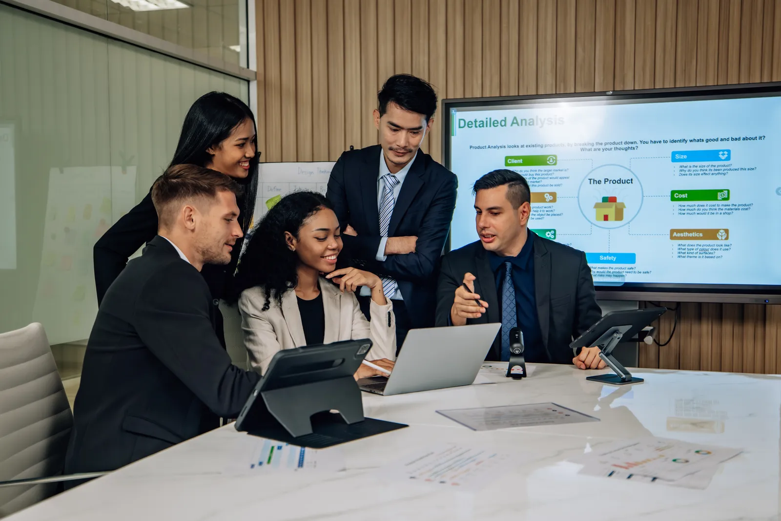B2B team reviewing campaign dashboards in a boardroom