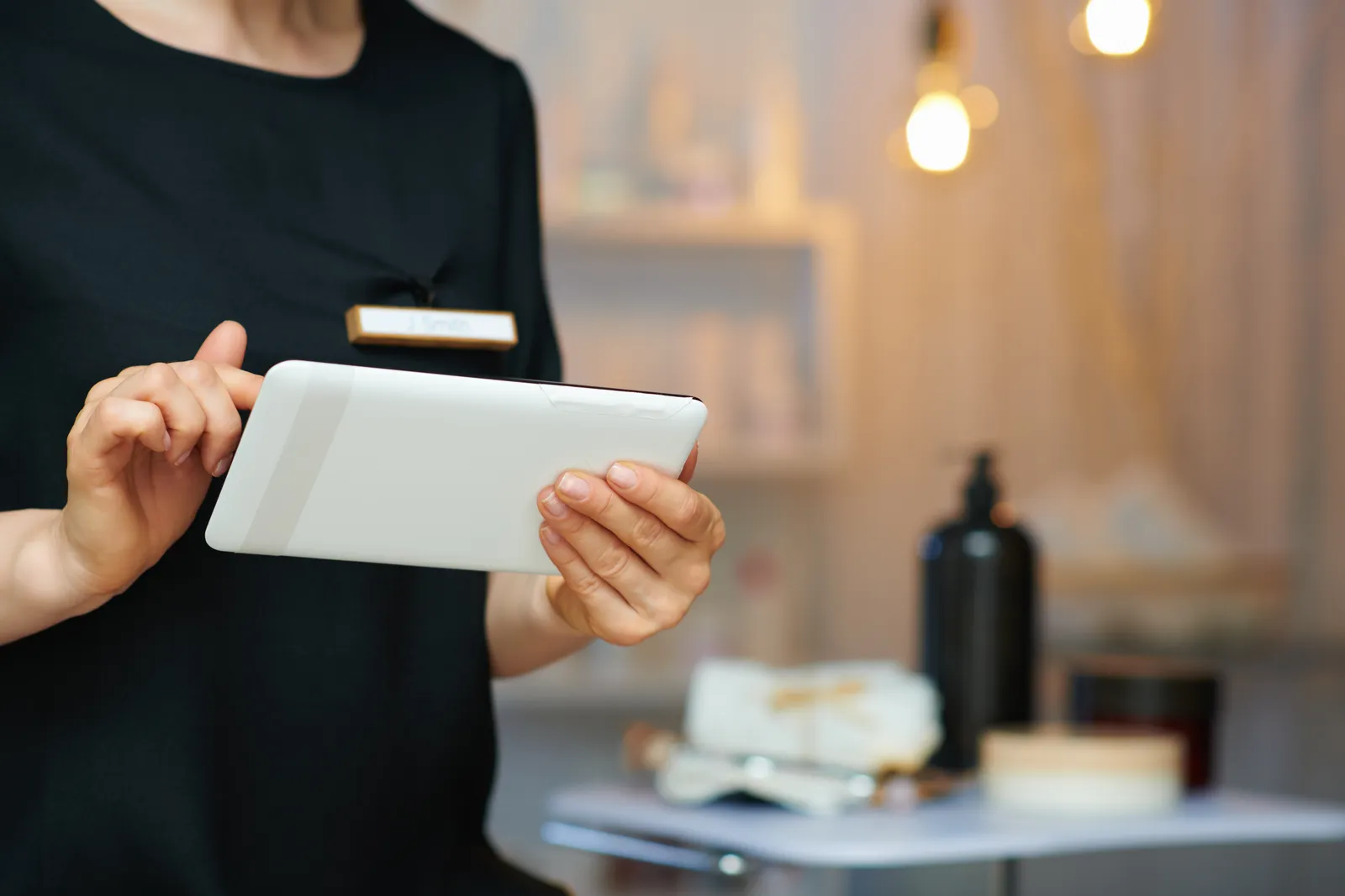 Salon owner updating her booking site on a tablet