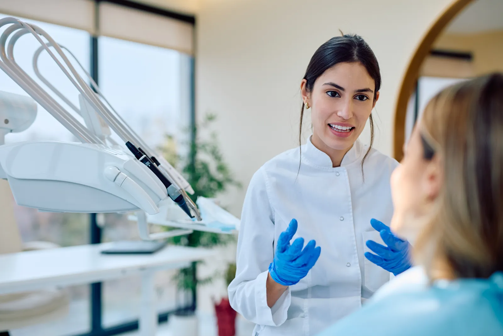 Dentist talking with a patient in a treatment room