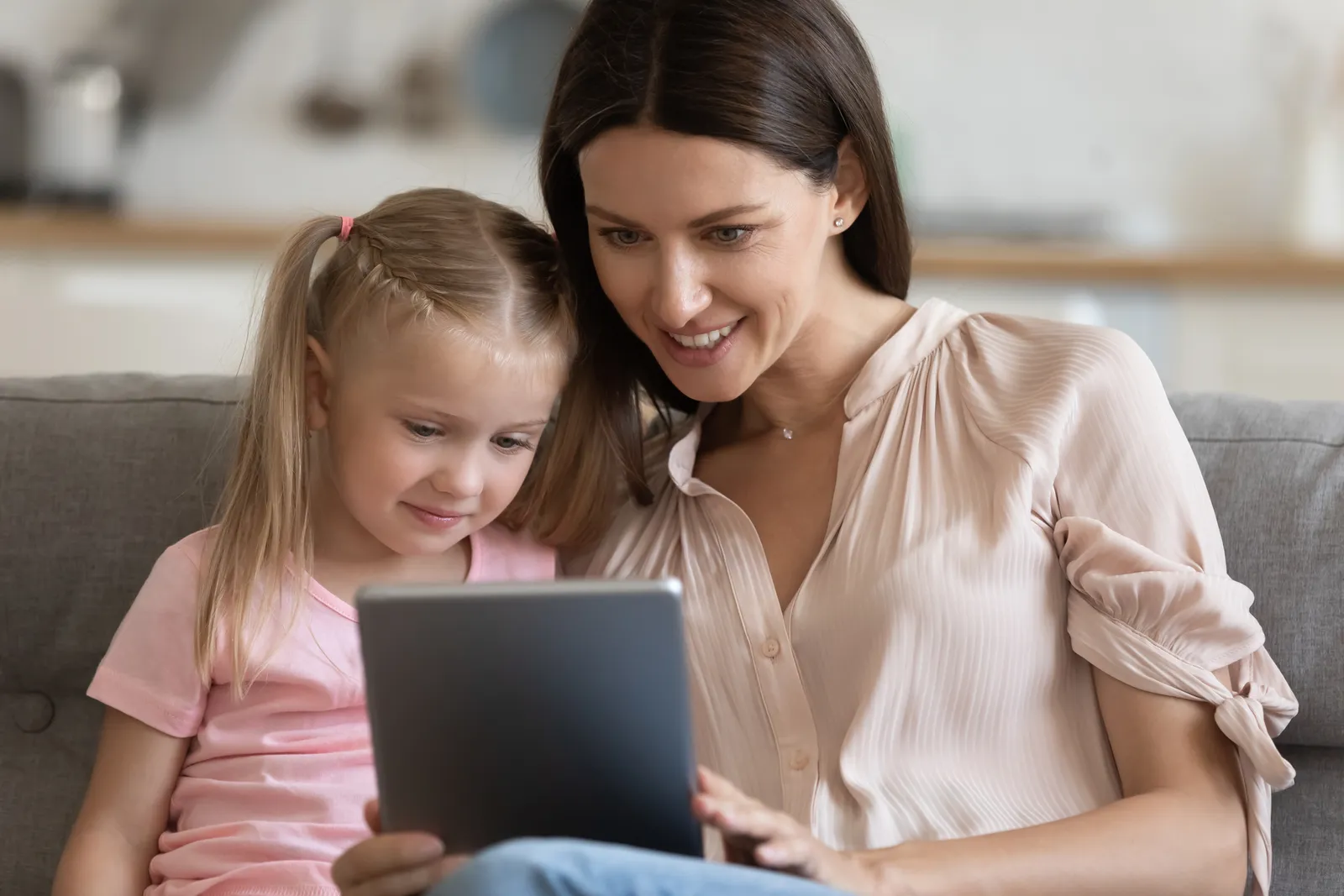 Parent and child exploring a school website on a tablet