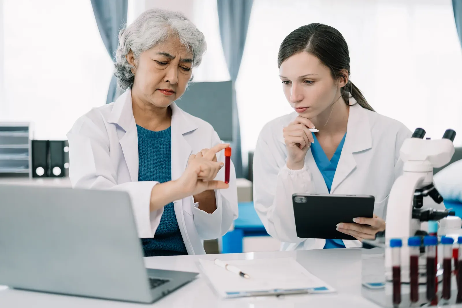 Physician reviewing bloodwork results with a patient during a hormone therapy consultation