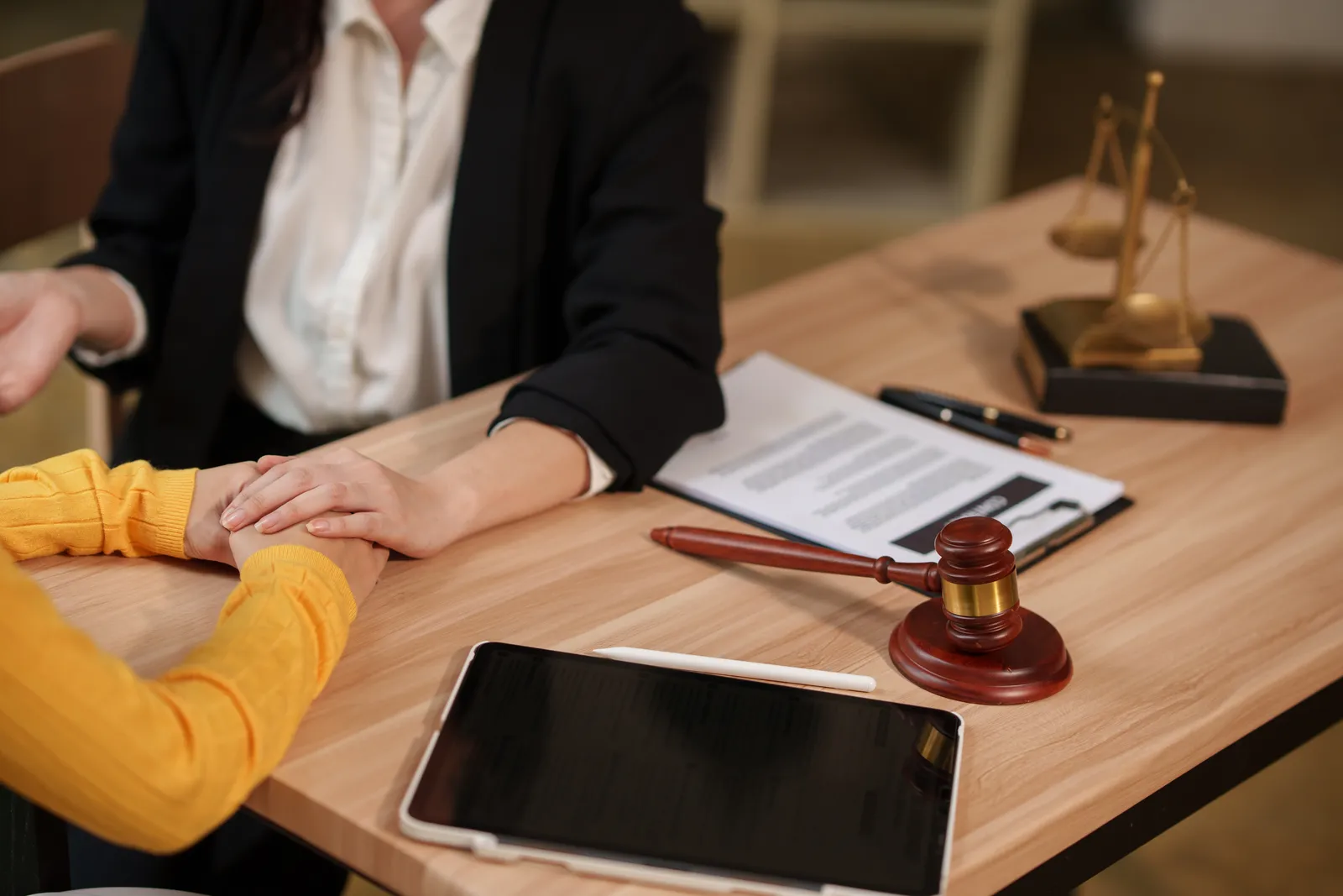 Lawyer's desk with a gavel and scales during a client consultation