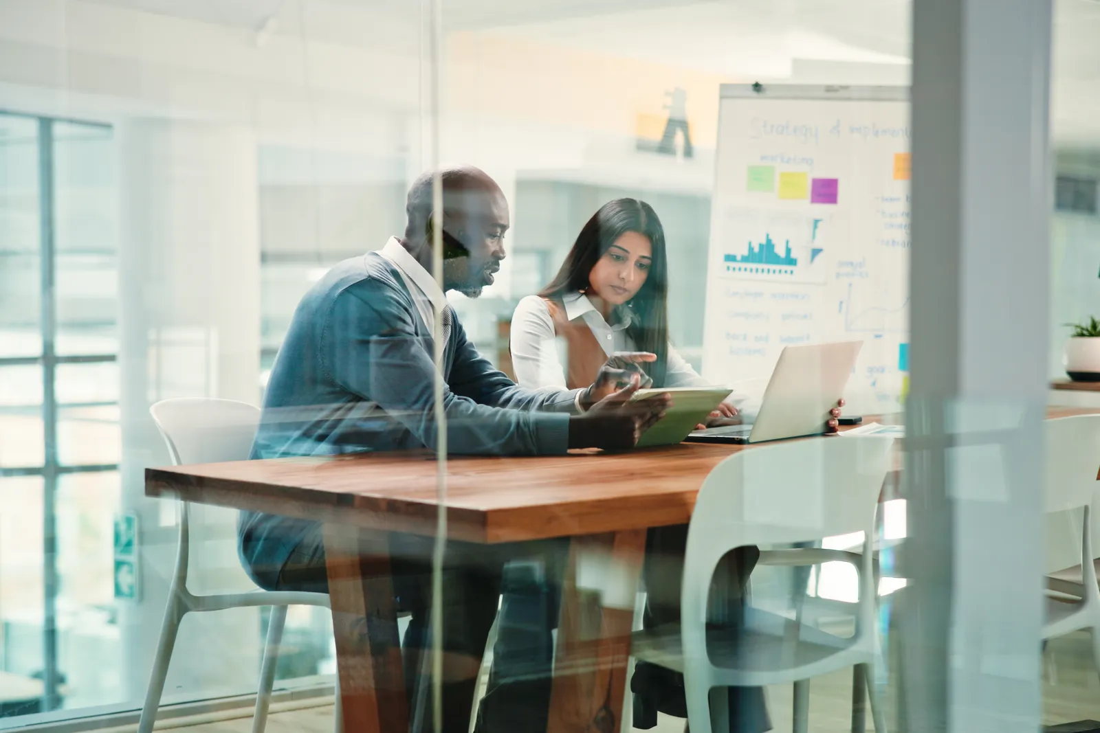 In-house marketer and agency specialist working together at a shared desk