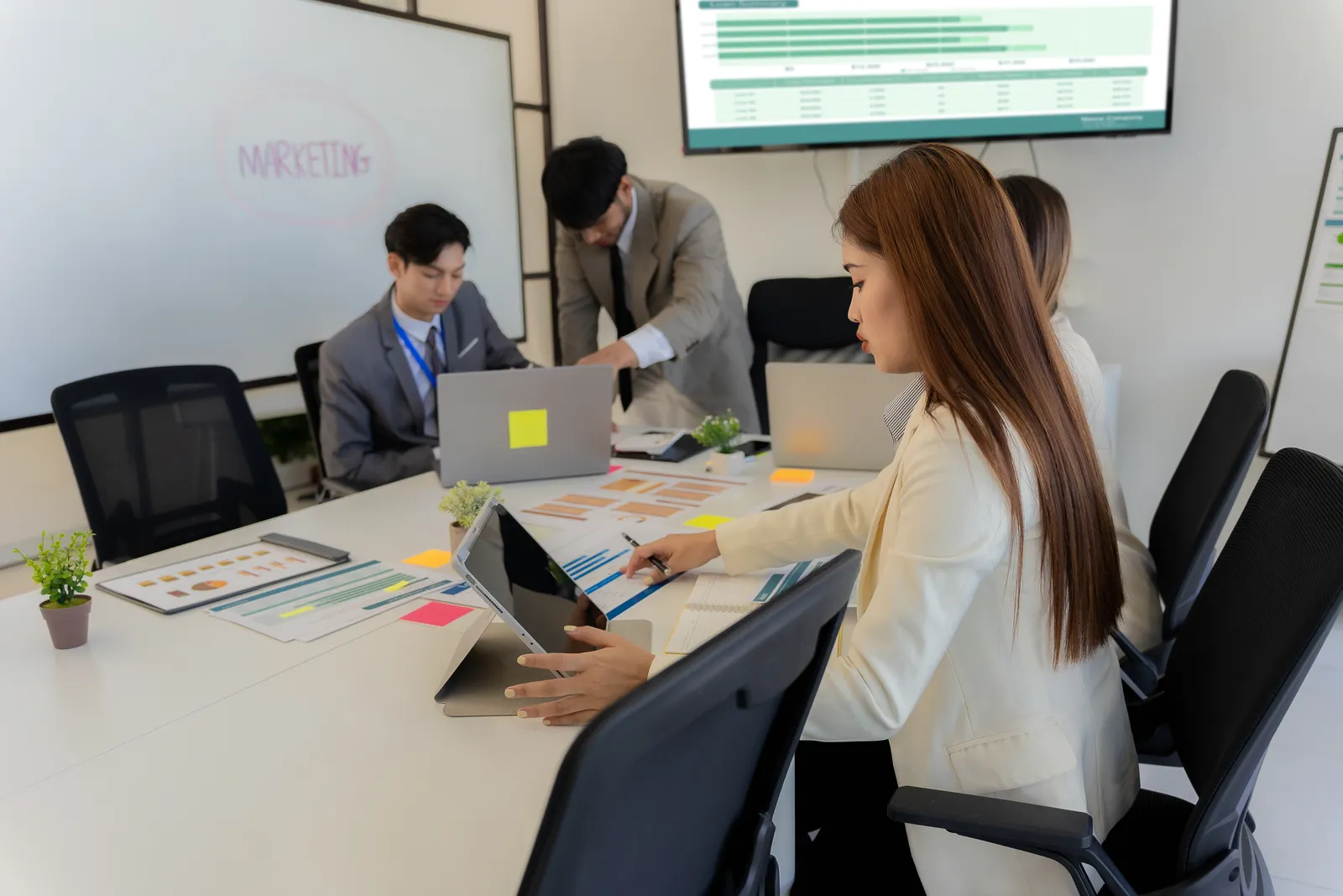 Leadership team reviewing marketing performance charts in a meeting room