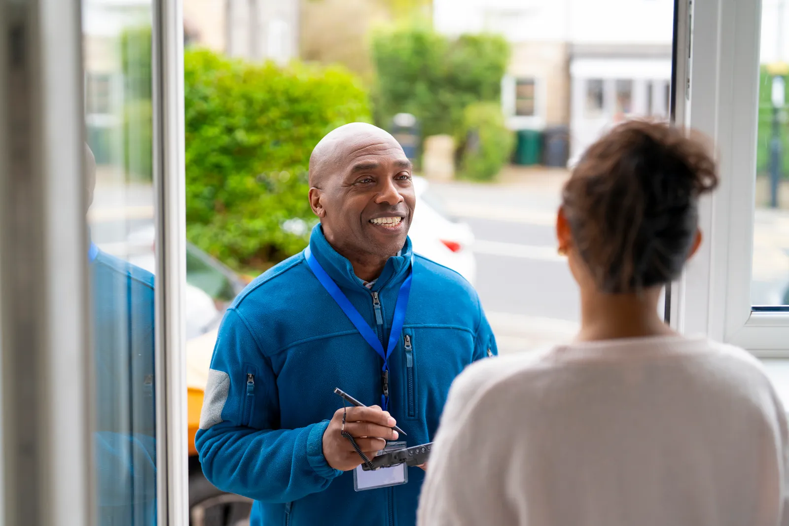 Real estate agent greeting a visitor at an open house