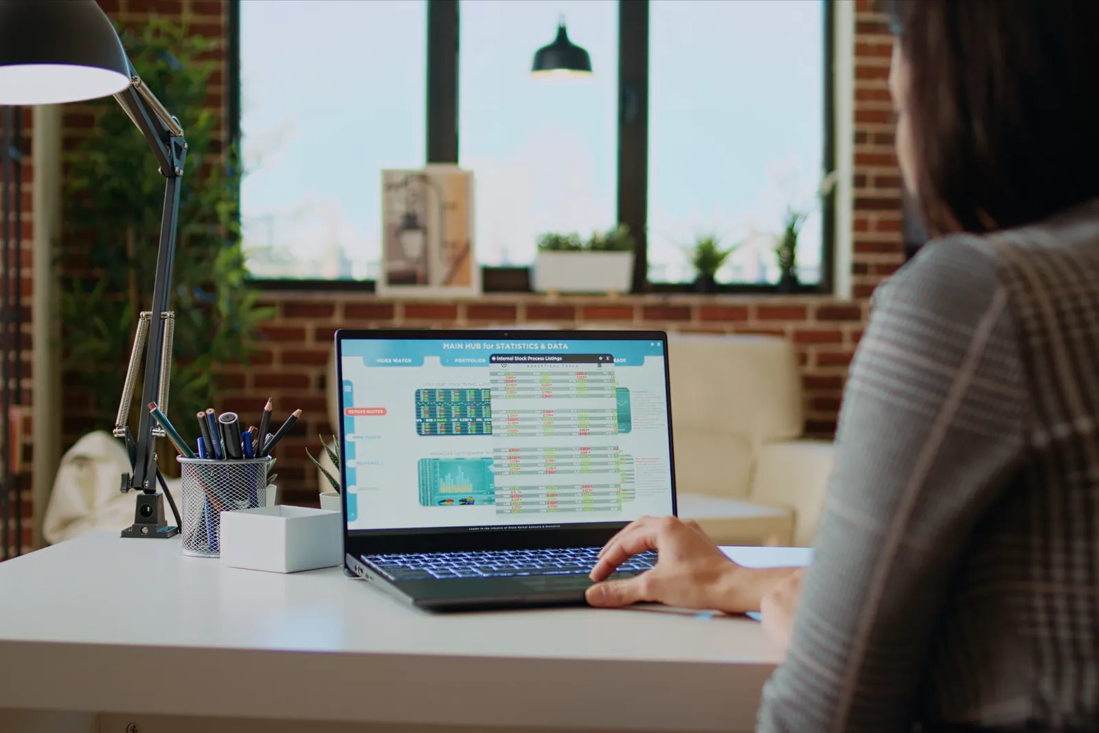 Laptop showing a product dashboard on a workspace desk