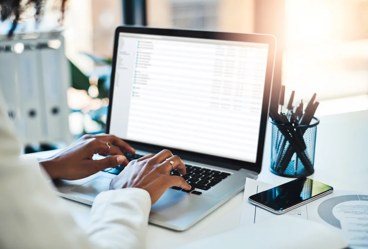 A marketer mapping an automated email nurture sequence on a laptop dashboard in a bright office