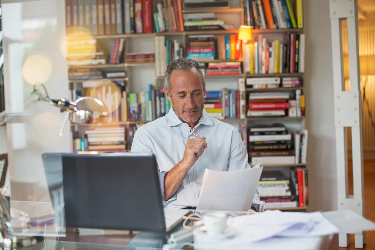 A business owner reviewing lead follow-up emails on a laptop in a bright office workspace