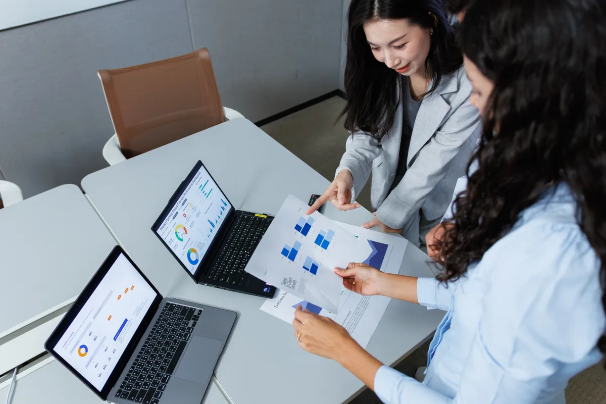 Operations team reviewing a custom internal dashboard on a laptop, replacing a shared spreadsheet workflow