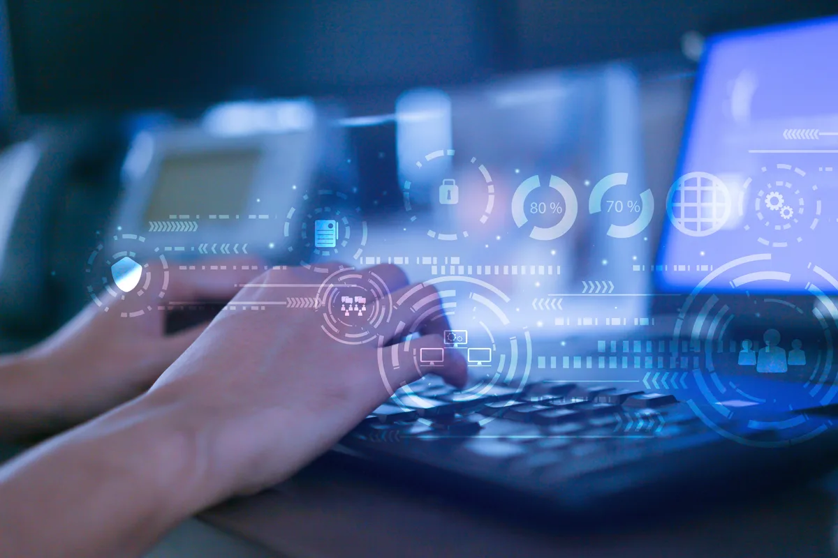 A developer mapping data fields between a website form, a CRM, and accounting software on a laptop