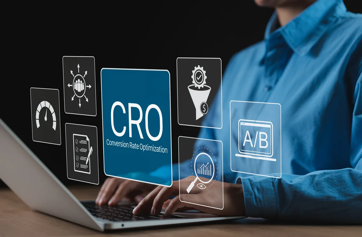 A marketer reviewing landing page conversion data and Google Ads metrics on a laptop screen