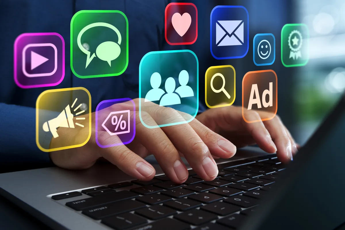 A paid-search specialist scanning a search terms report on a wide monitor to find wasted ad spend