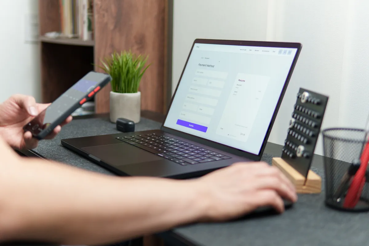 A store owner reviewing their e-commerce checkout and product pages on a laptop to find conversion fixes that don't require a new theme