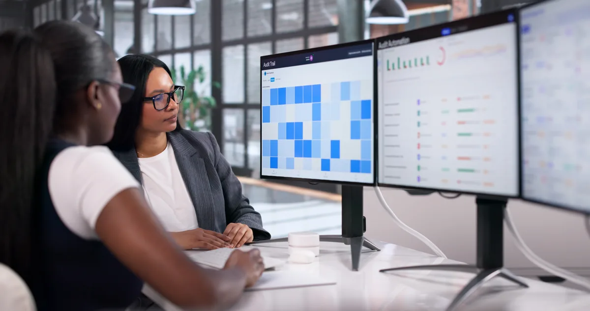 Analytics specialist inspecting a tag management setup across two monitors while testing a website