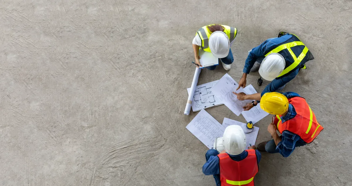 General contractor reviewing renovation plans with a homeowner on site