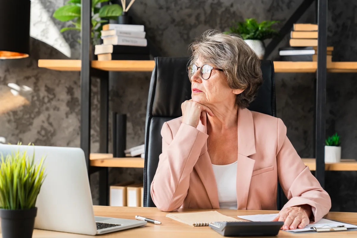 Small business owner on a phone call reviewing Google Ads conversion data on a laptop, representing tying phone calls and offline sales back to ad campaigns