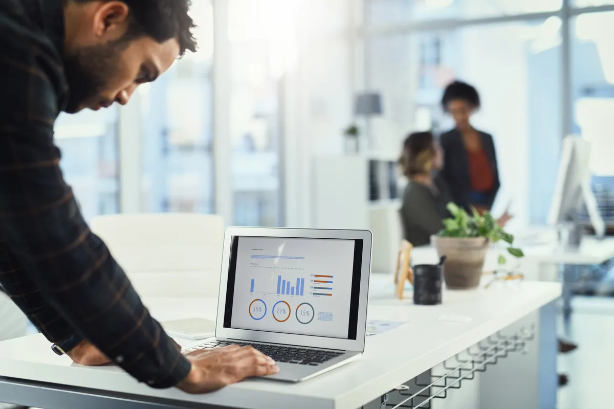 Business owner reviewing marketing return-on-investment figures on a laptop dashboard