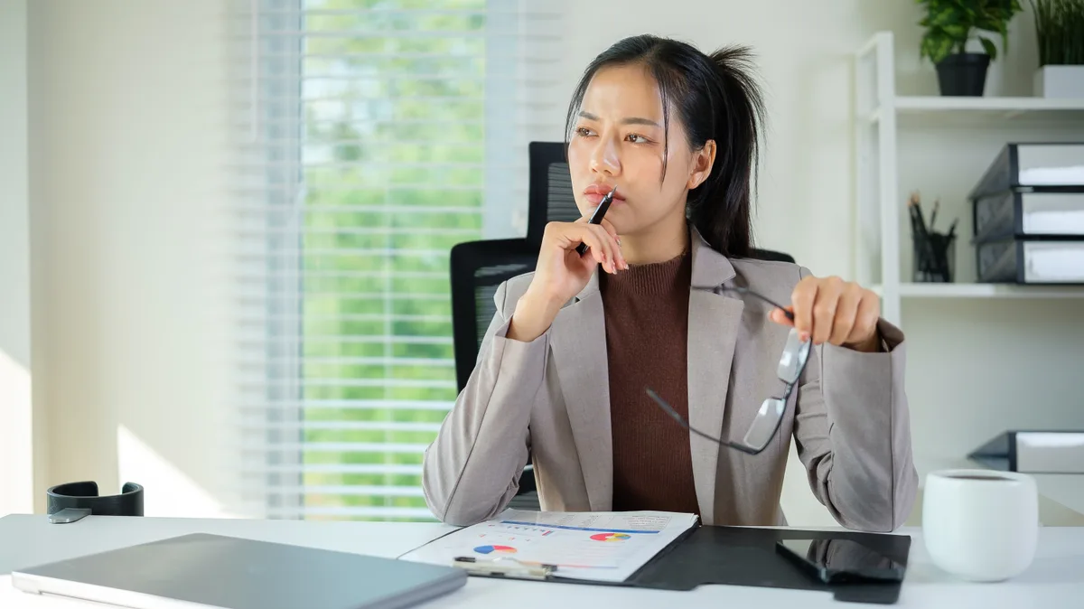 Business owner at a desk reviewing a Google Ads budget and conversion report on a laptop before deciding whether the campaign is working