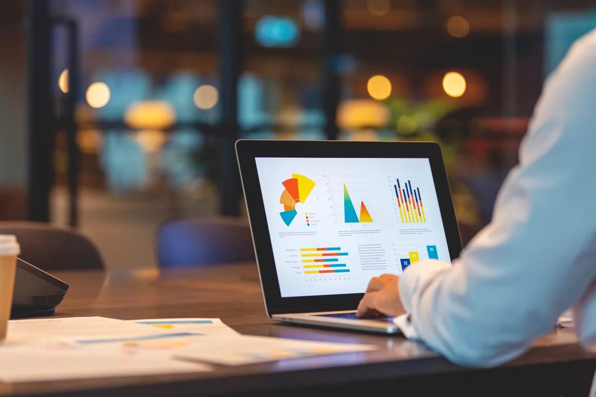 A digital marketing analyst comparing Google Ads conversion data across two monitors to diagnose tracking issues