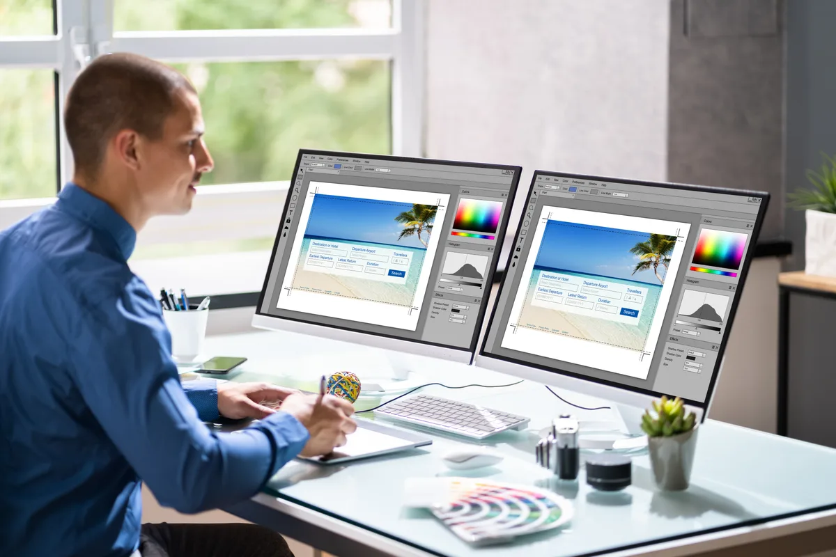 Marketer comparing a homepage and a focused landing page side by side on a desktop monitor