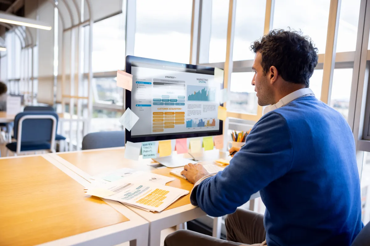 SEO specialist auditing a list of website pages by traffic and conversions on a desktop screen