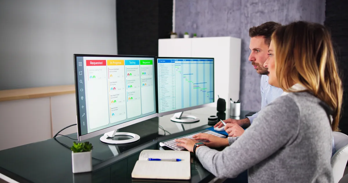 SEO specialist reviewing a site crawl and Core Web Vitals report on two monitors
