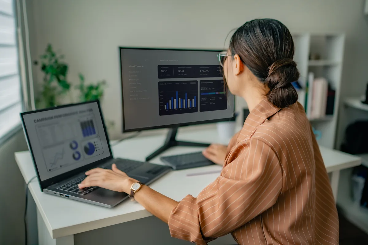 A business owner reviewing their own Google Analytics and ad account dashboards on a laptop, illustrating client-owned marketing assets