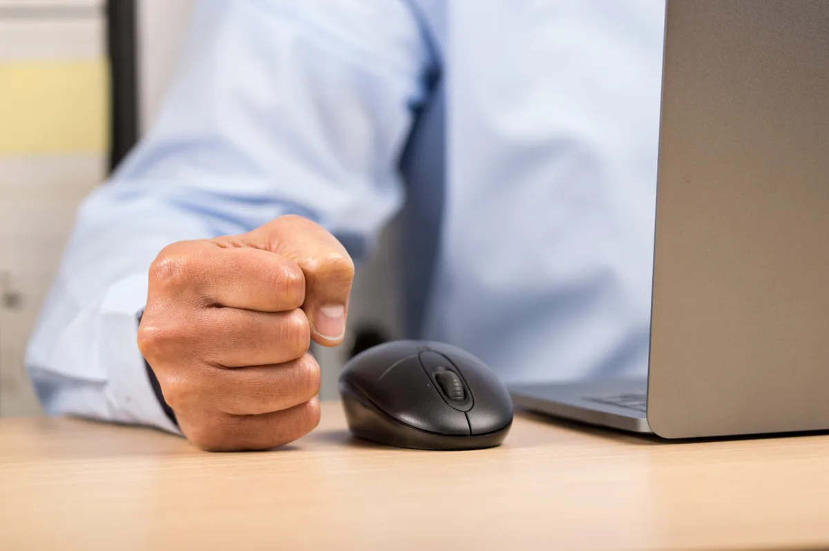 A small business owner reviewing their website on a laptop, trying to understand why visitors leave without making contact