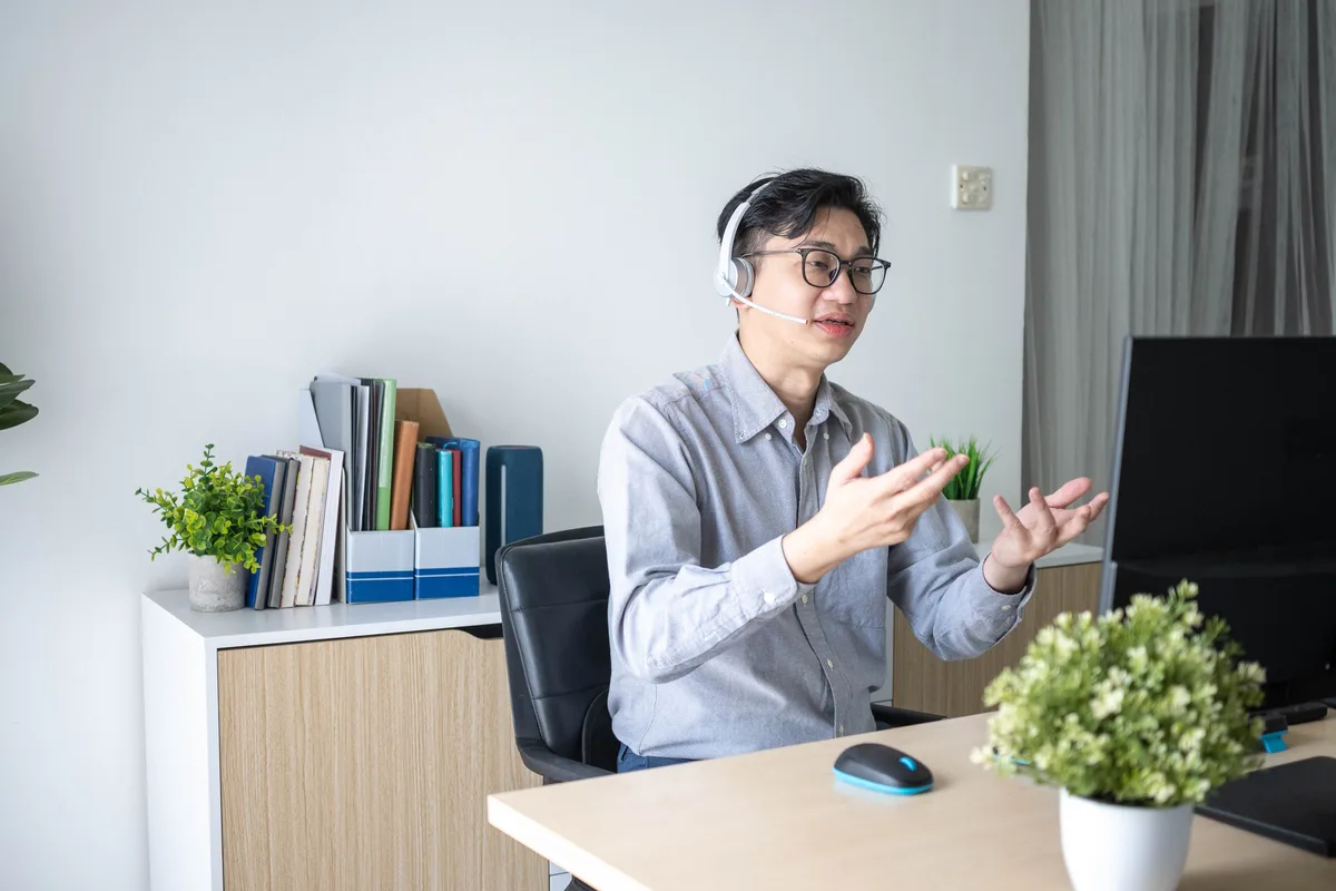A business owner comparing competitors on a laptop while reviewing why an AI assistant recommends other companies