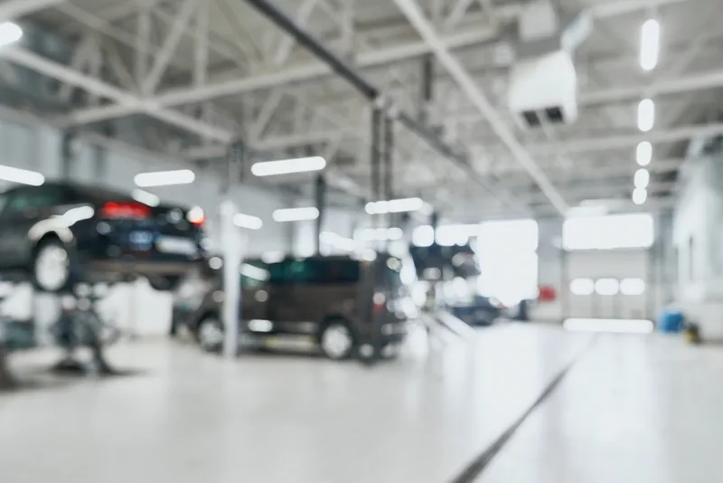 Bright service hall with cars raised on lifts