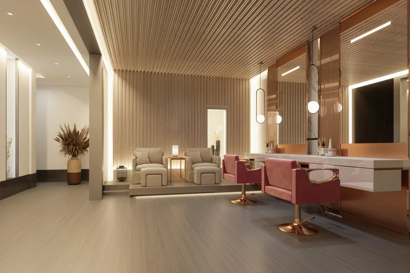 Studio Mer's styling floor: rose-velvet chairs at copper-framed mirrors under a slatted wood ceiling, warmly lit
