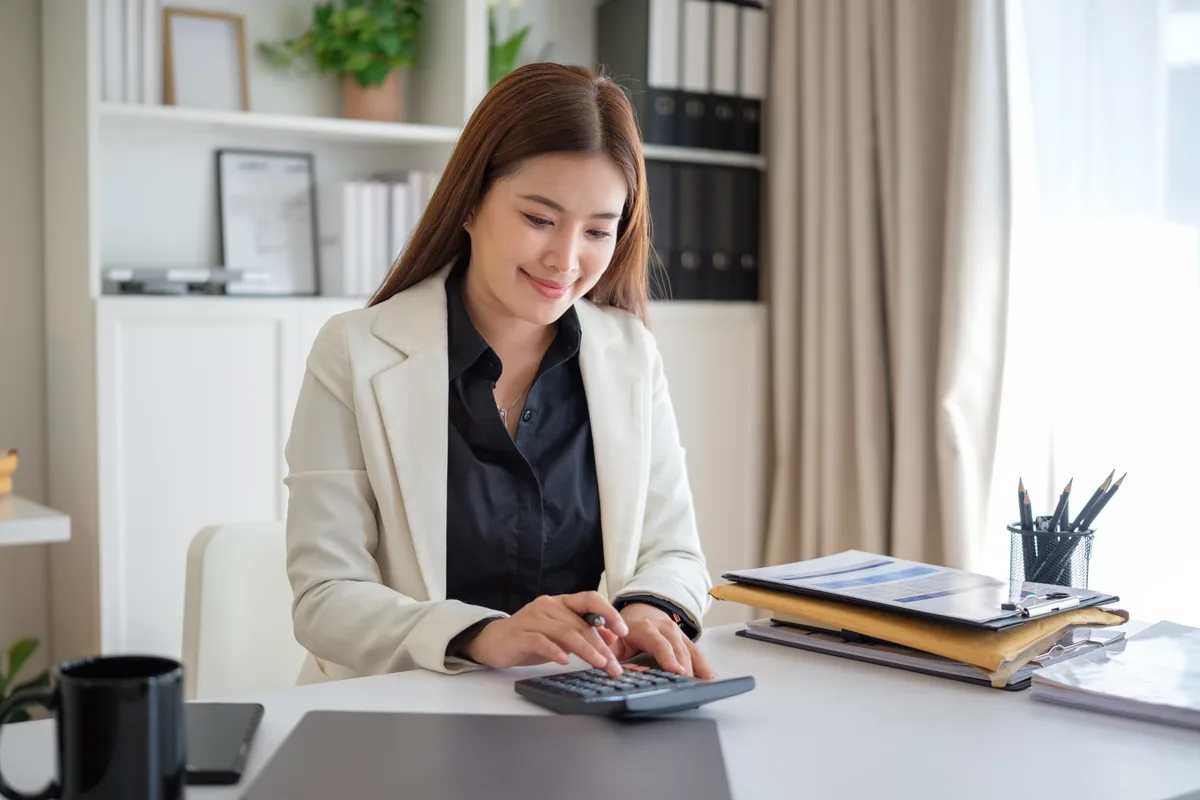 An accountant reviewing financial statements across a desk from a small-business owner during a consultation