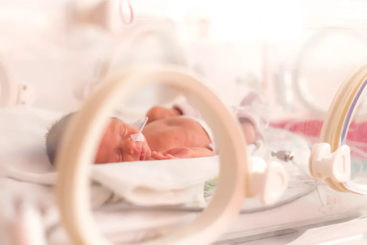 Birth injury attorney reviewing a child's medical records and life-care plan with the parents at a law office conference table