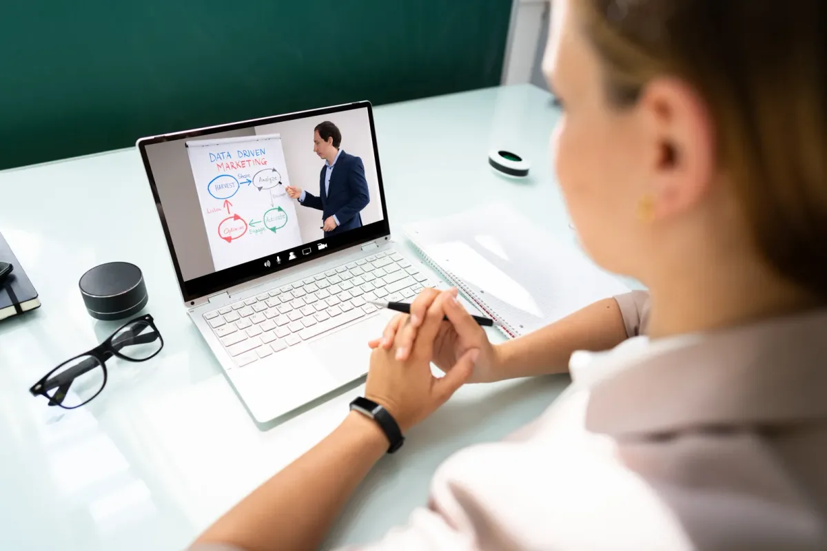 Instructor teaching a live online cohort based course over video call with students visible in a grid