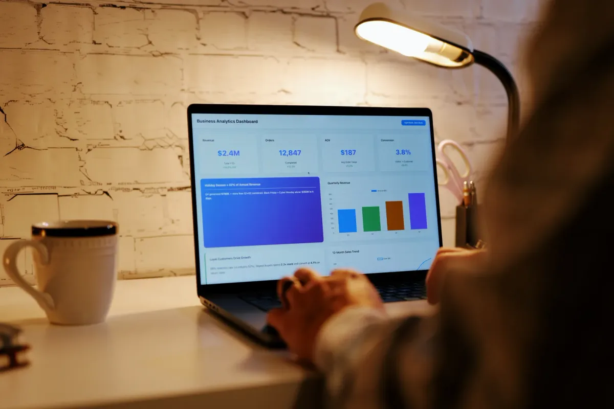 Creator reviewing membership renewal and churn numbers for their subscription business on a laptop