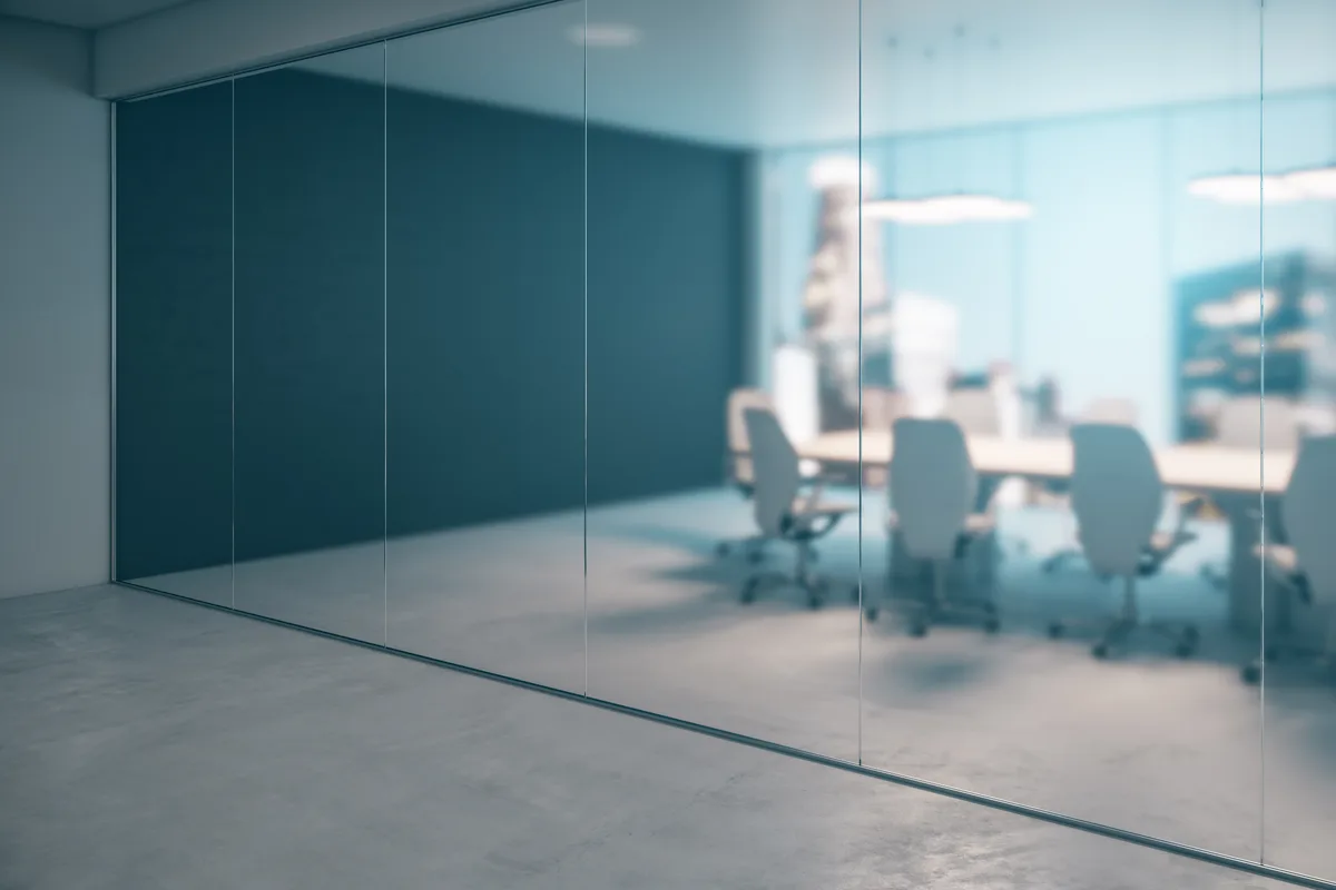 A criminal defense attorney reviewing a case with a client across a desk in a law office