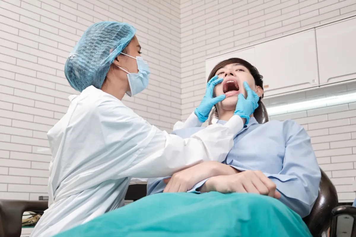 A dentist and assistant treating a patient during a same-day emergency dental visit