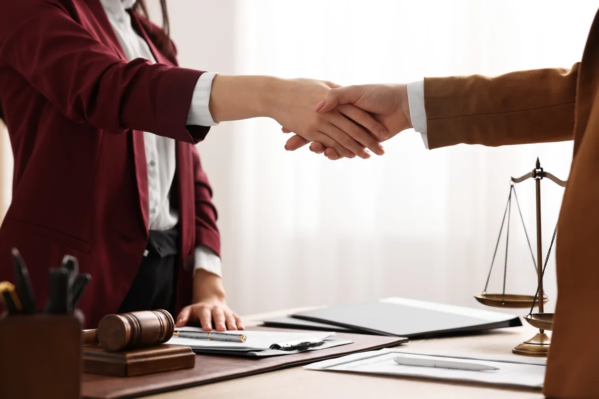 Family law attorney meeting a prospective client across a desk in a law office