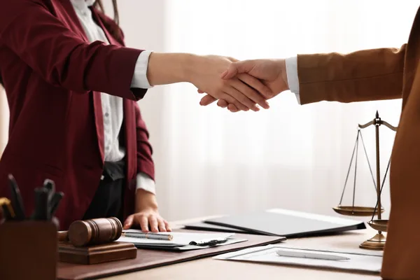 Family law attorney meeting a prospective client across a desk in a law office