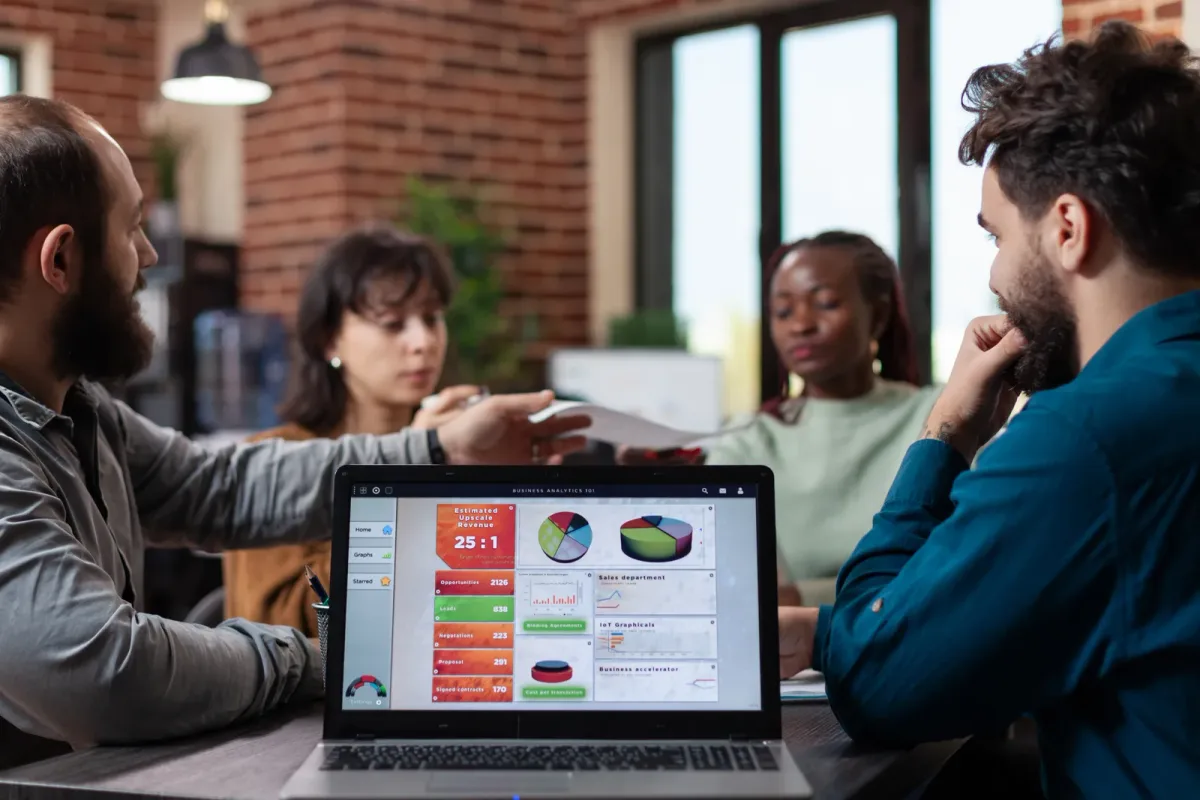 A software user reviewing a pricing and plan comparison page on a laptop screen