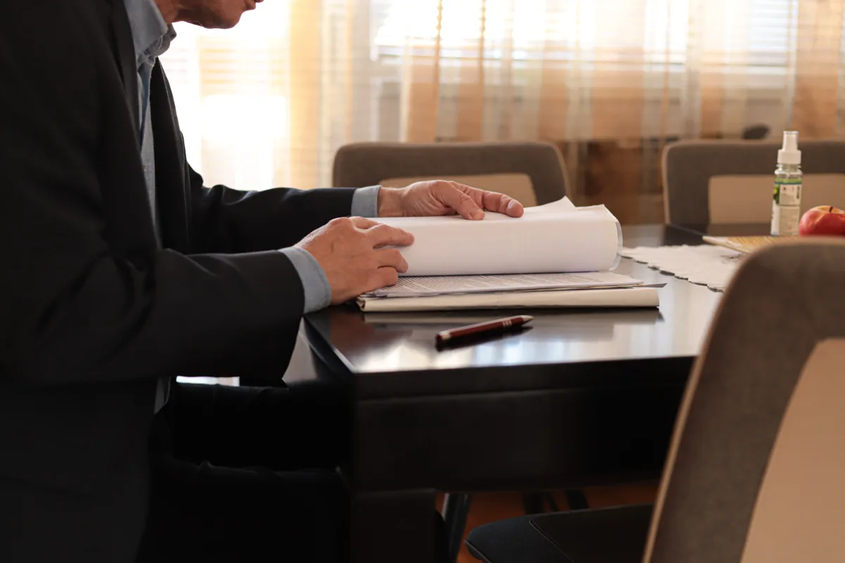 Mass tort attorney reviewing claimant intake and litigation files at a conference table