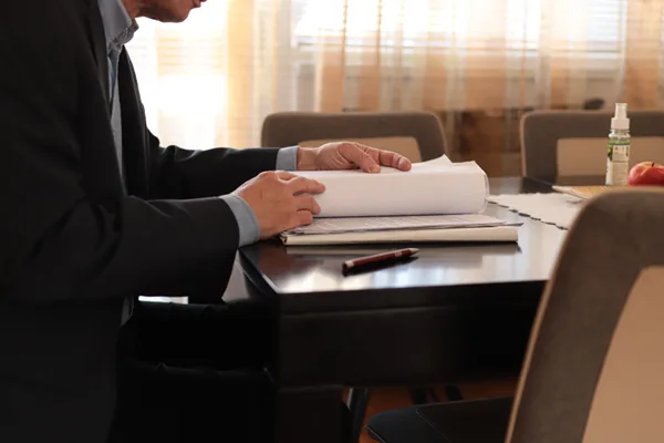 Mass tort attorney reviewing claimant intake and litigation files at a conference table