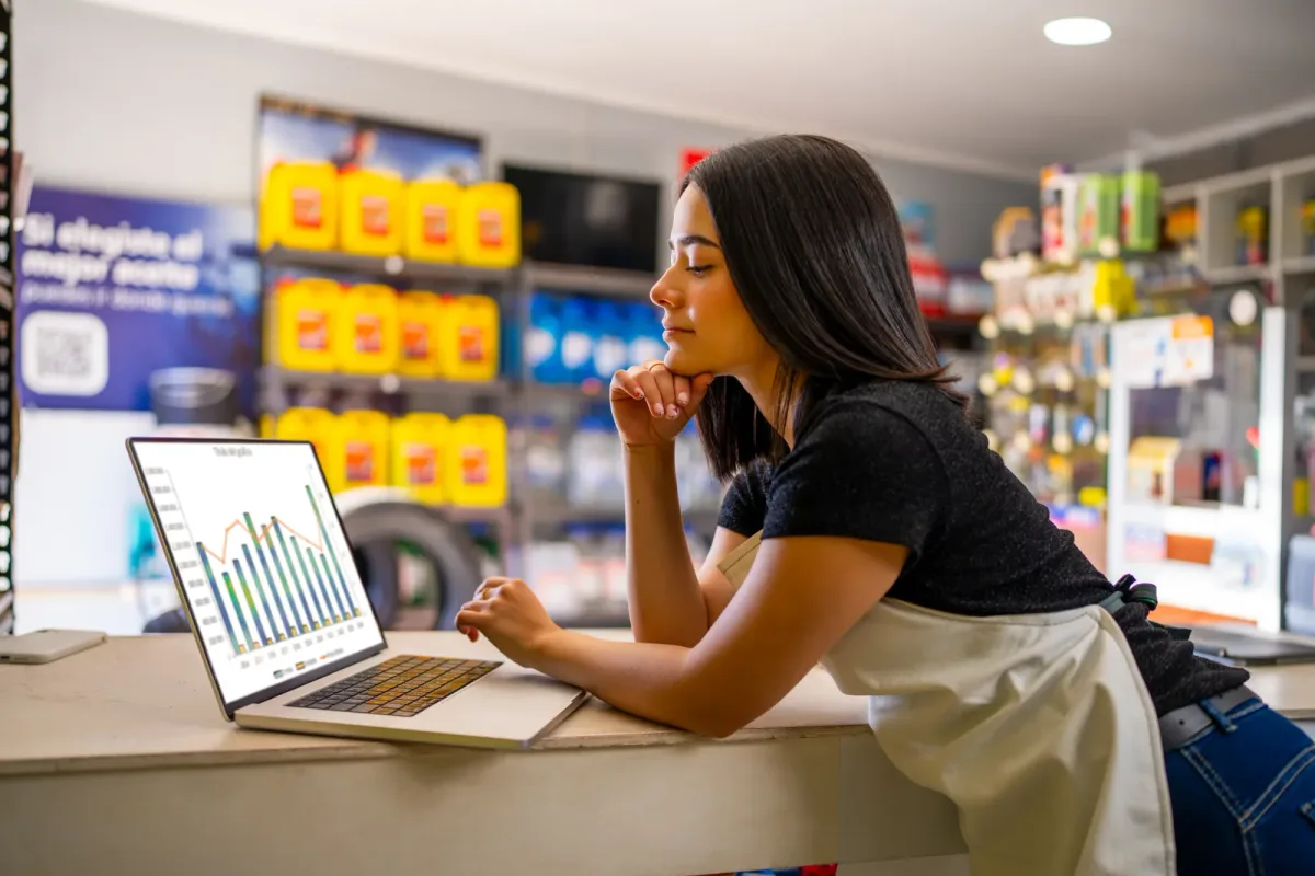 A retail store employee scanning a barcode on merchandise at a point of sale terminal
