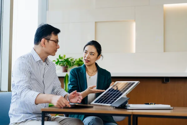 A solar installation company owner reviewing marketing performance with an agency partner