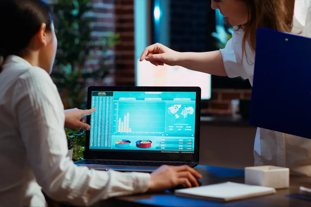 Treasury software vendor team reviewing a demo-to-funded-account pipeline dashboard on a laptop