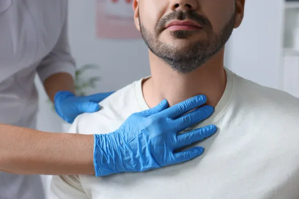 Endocrinologist reviewing thyroid and blood sugar lab results with a patient in an exam room